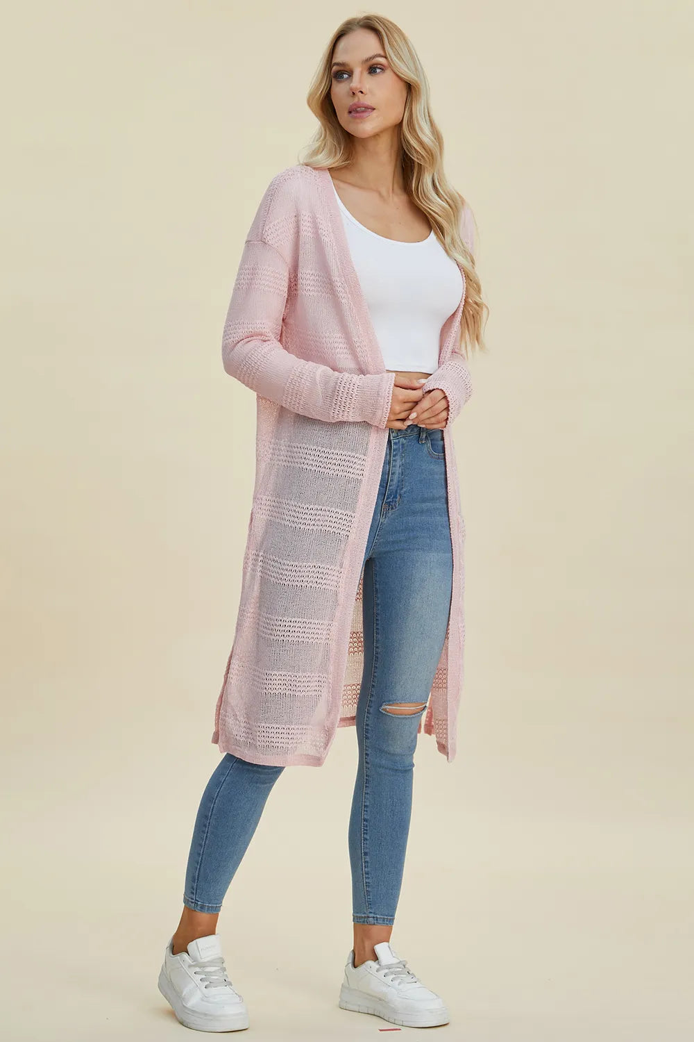 Black Trendsi Double Take full size open front longline cardigan hanging on a rack, showcasing its relaxed, draped style.