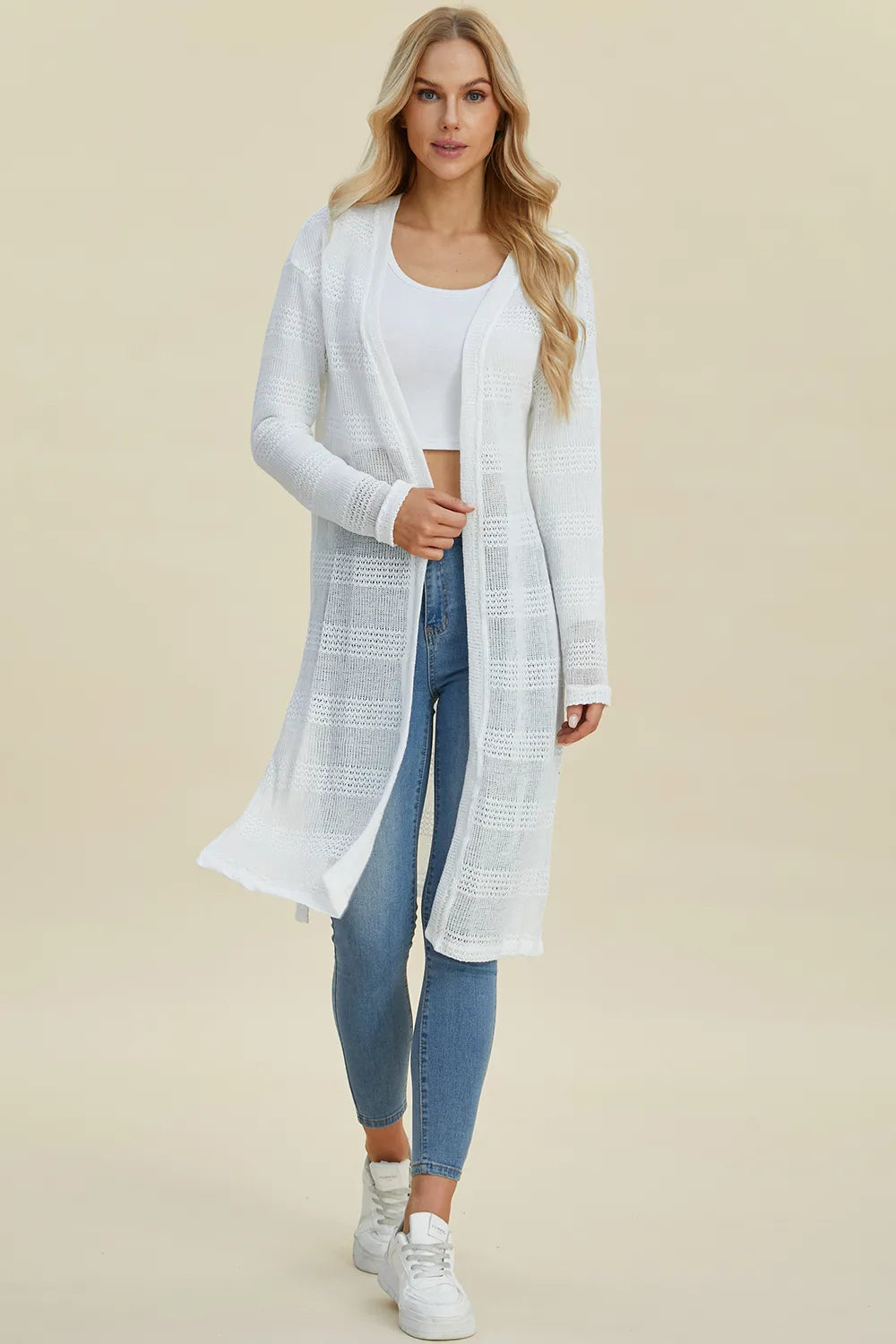 Black Trendsi Double Take full-size open front longline cardigan hanging on a clothing rack.