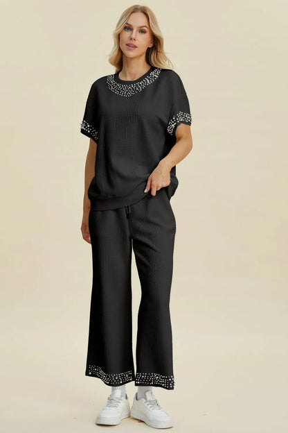 Black Trendsi Double Take pearl-detail round neck top and matching pants set, full size, stylish and elegant ensemble.