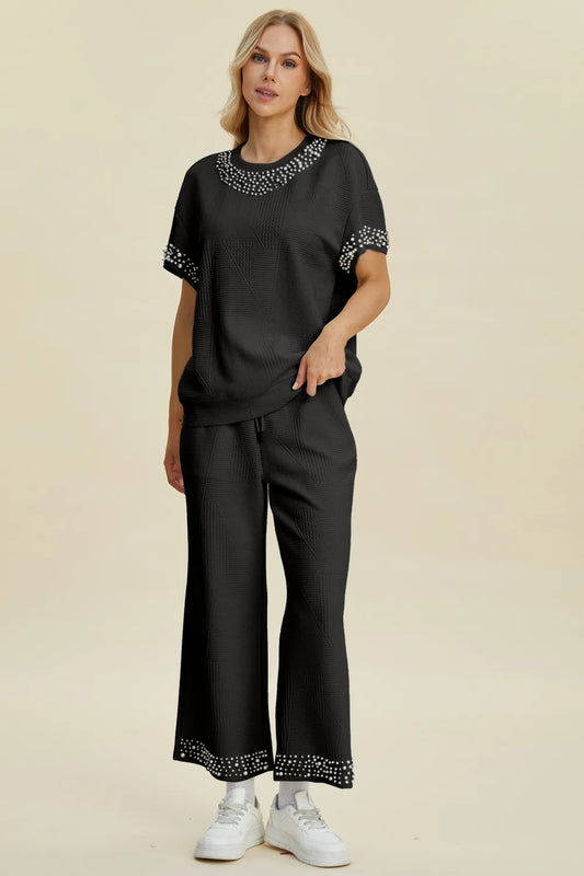 Black Trendsi Double Take pearl-detail round neck top and matching pants set, full size, stylish and elegant ensemble.