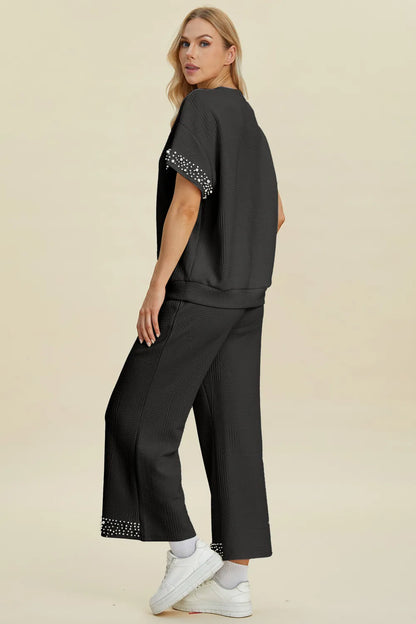 Black double take pearl detail round neck top and matching pants set by Trendsi, stylish and comfortable for casual wear.