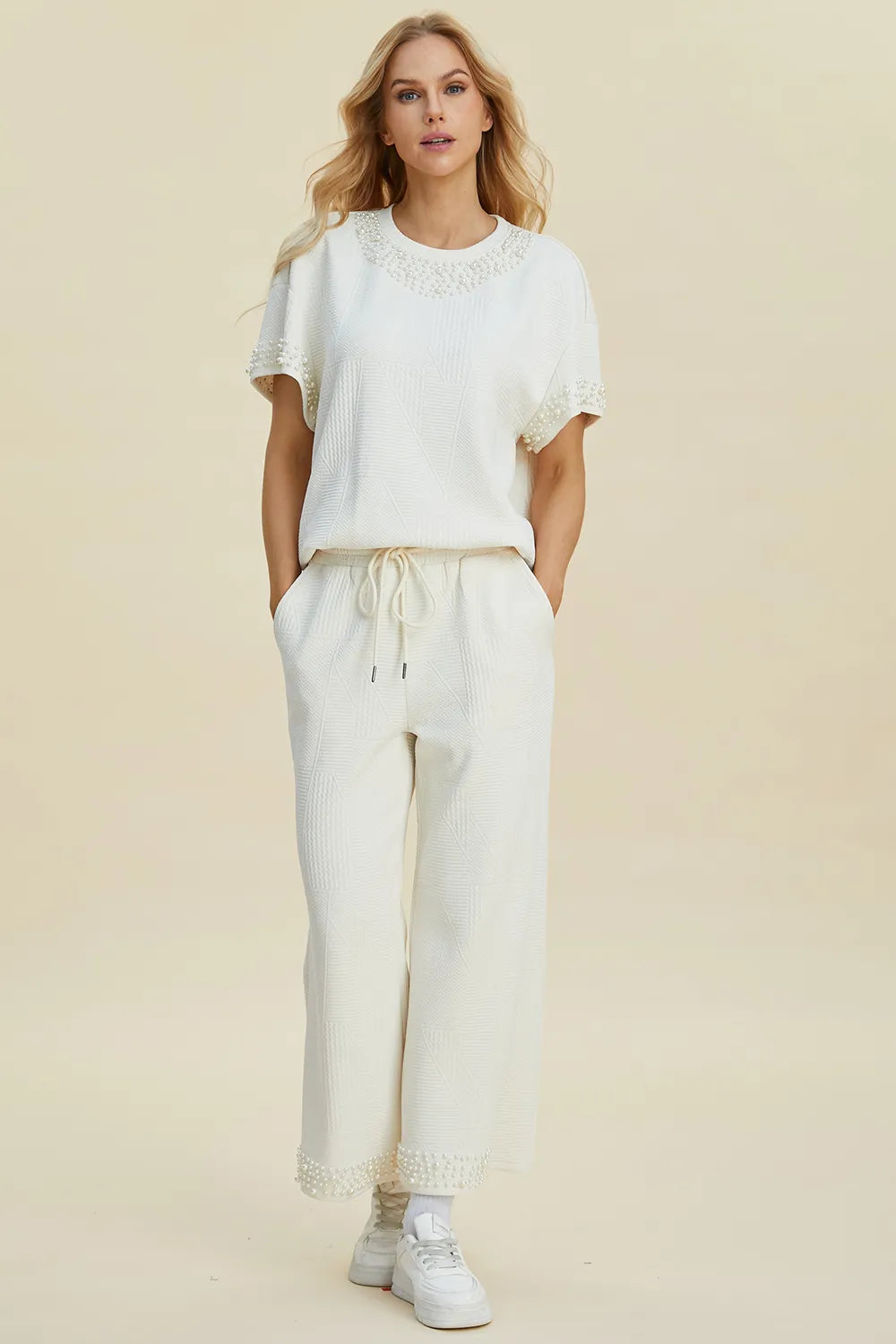 Black double take pearl detail round neck top and pants set by Trendsi, featuring elegant pearl accents and a coordinated stylish look.