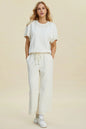 Black double take pearl detail round neck top and pants set by Trendsi, featuring elegant pearl accents and a coordinated stylish look.