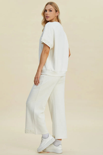 Black double take pearl-detail round neck top and pants set by Trendsi, stylish full-size women's matching outfit.