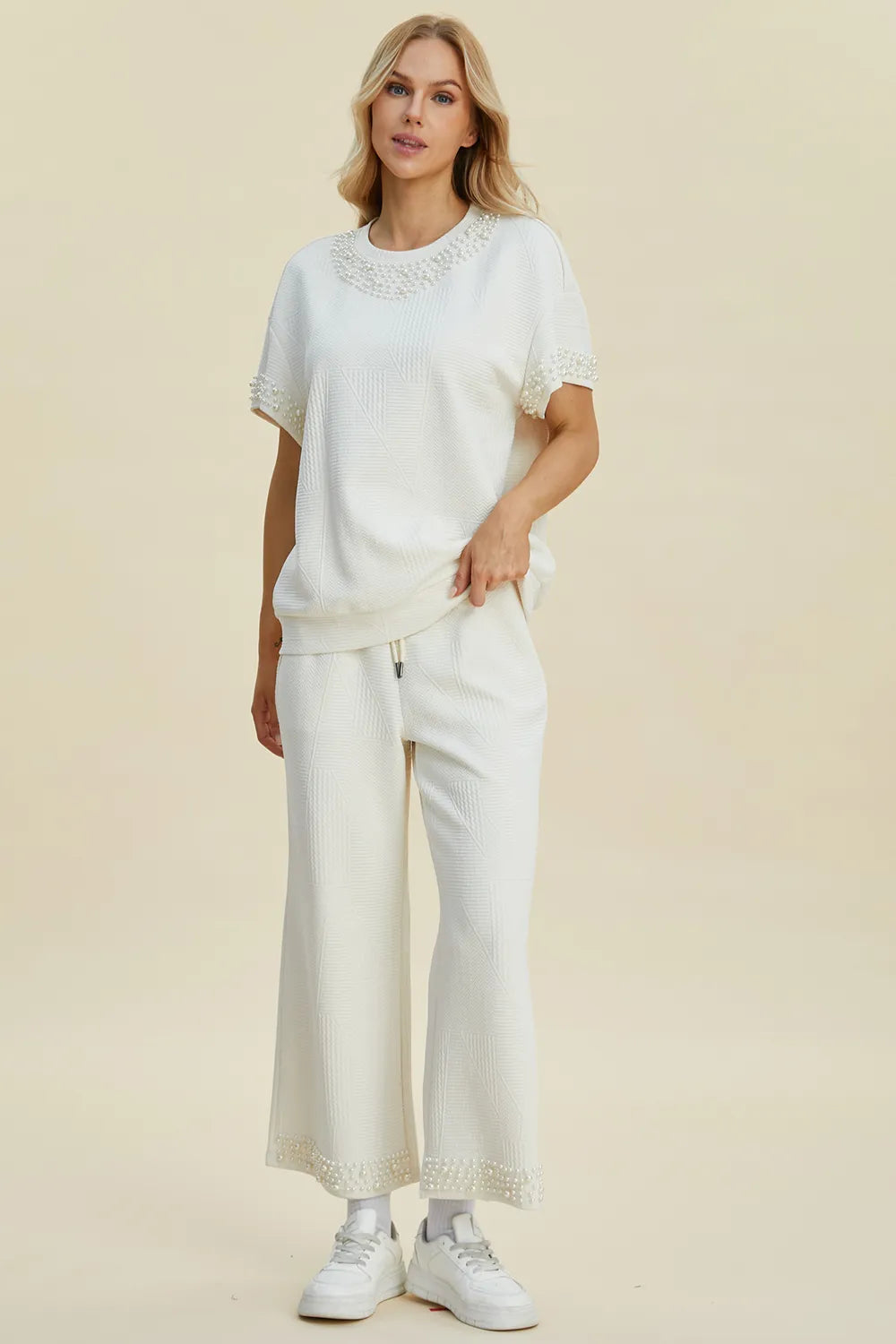 Black double take pearl detail round neck top and pants set by Trendsi, featuring elegant pearl accents and a coordinated stylish look.