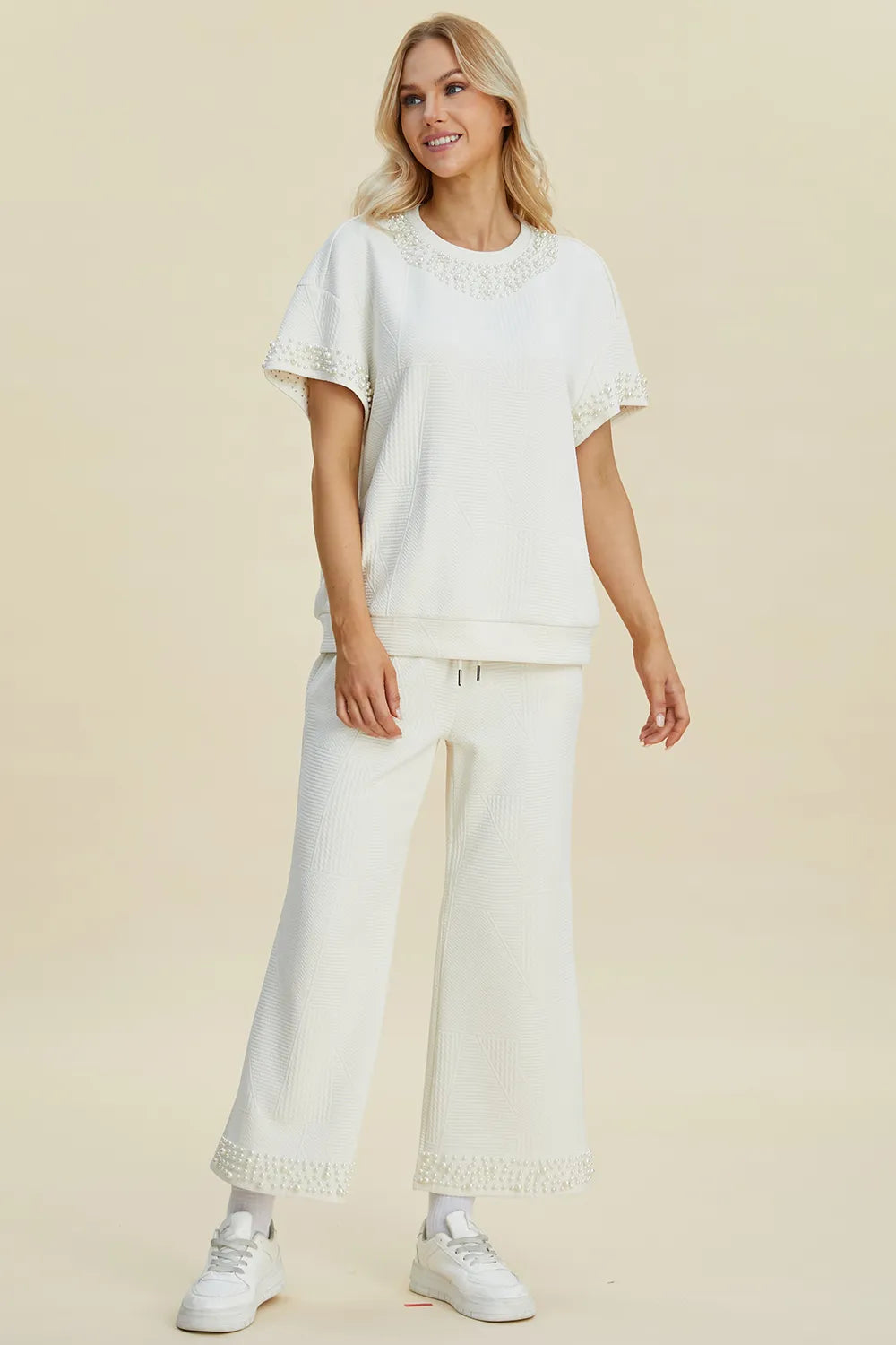 Black double take pearl detail round neck top and pants set by Trendsi, stylish full-size women's outfit with elegant pearl accents.