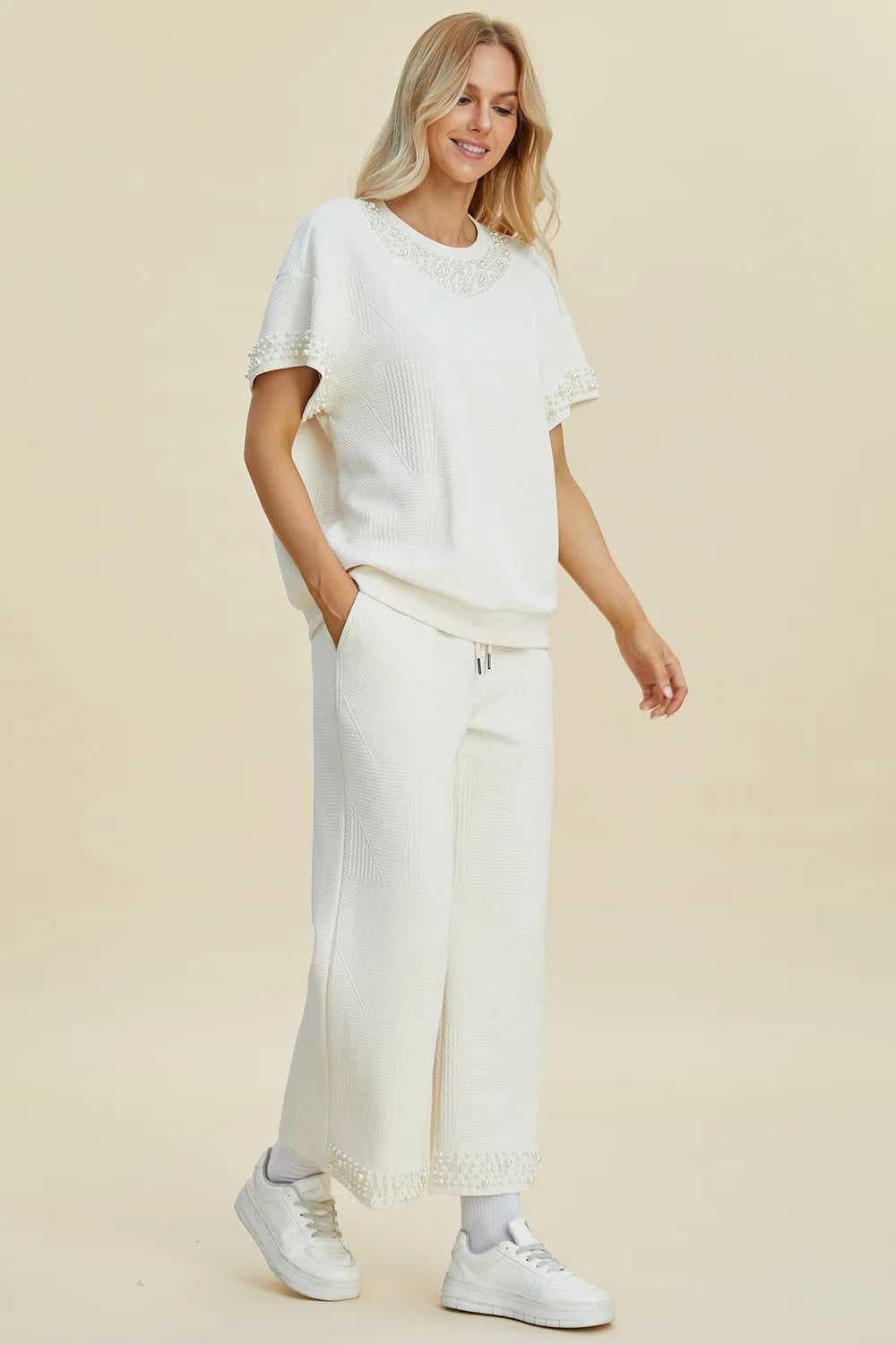 Black double take pearl detail round neck top and pants set by Trendsi, featuring elegant pearl accents and a stylish, coordinated look.