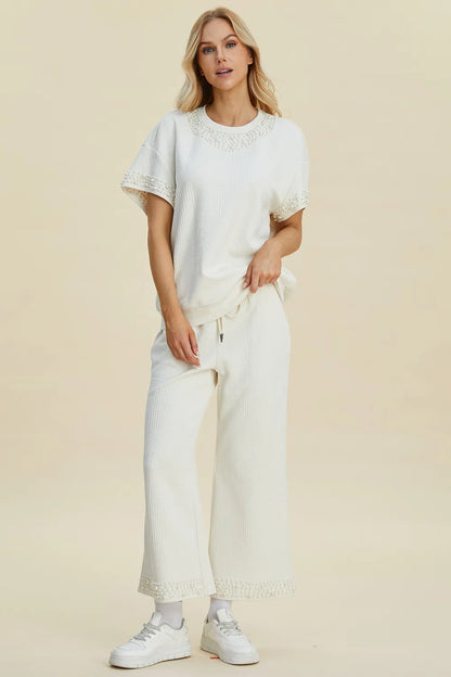 Black double take pearl detail round neck top and matching pants set from Trendsi, stylish full-size women's outfit.