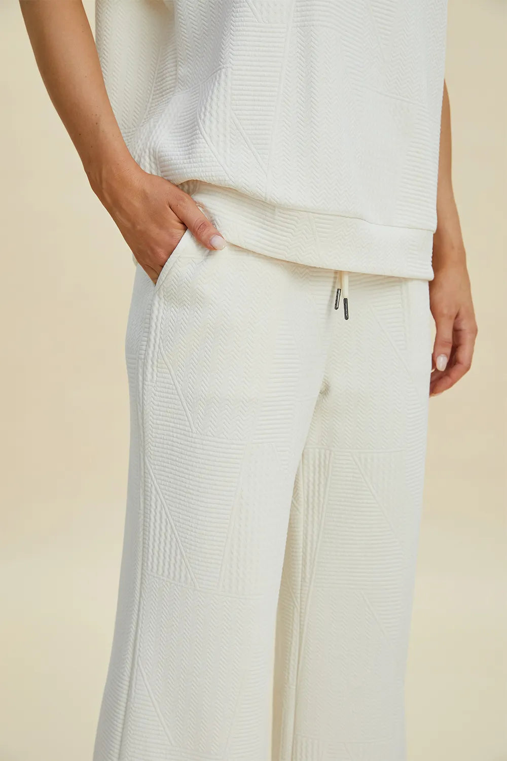 Black double take pearl detail round neck top and pants set by Trendsi, featuring elegant pearl accents and a coordinated look.