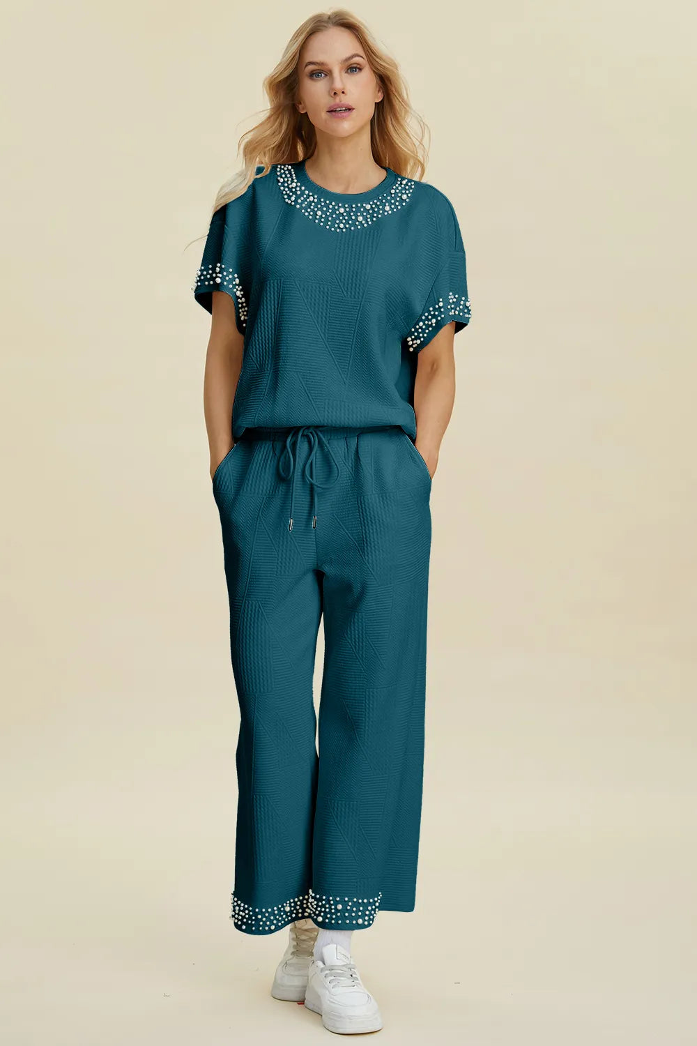 Black double take pearl detail round neck top and pants set by Trendsi, stylish full-size women's outfit with elegant pearl accents.