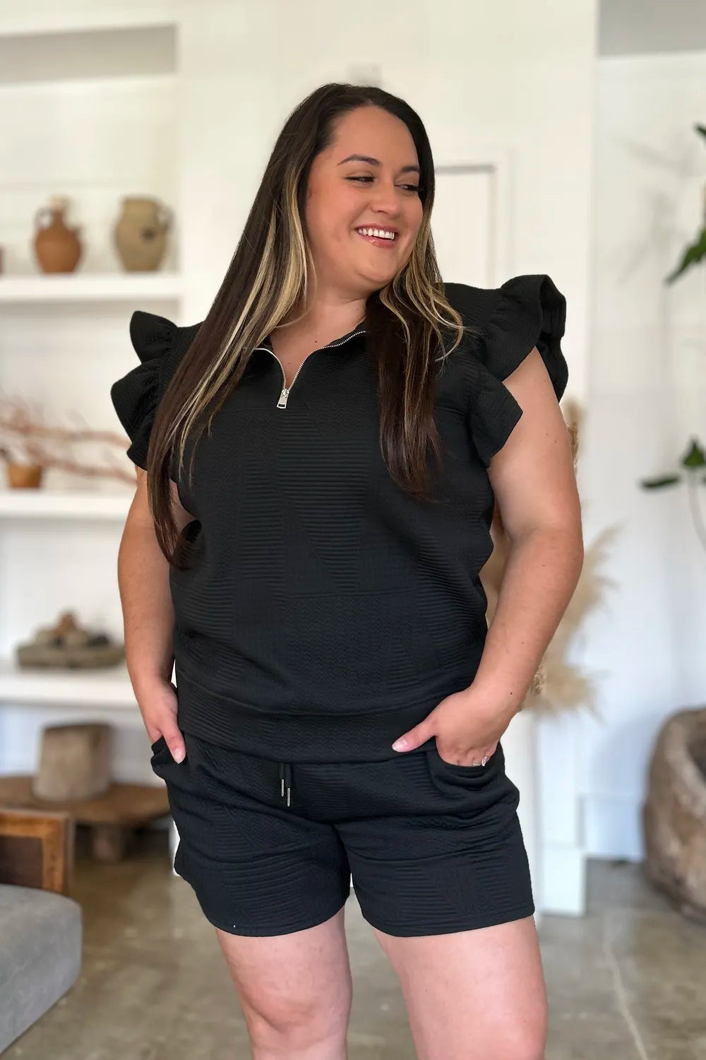 Black double take texture flounce sleeve top and shorts set by Trendsi, featuring stylish sleeves and a coordinated summer outfit.