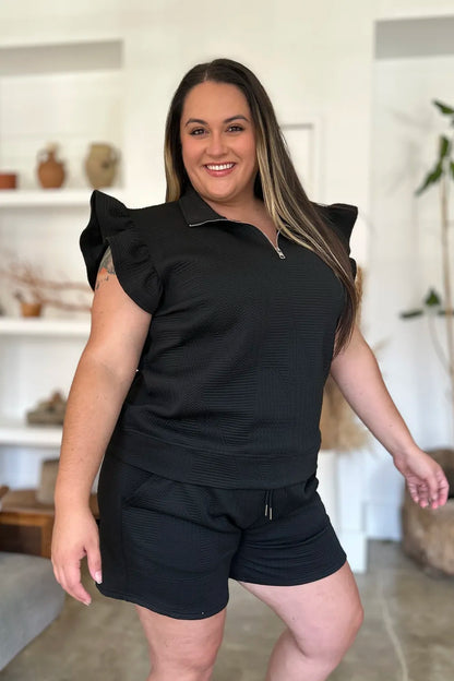 Black double take texture flounce sleeve top and shorts set by Trendsi, featuring stylish design and comfortable fit.