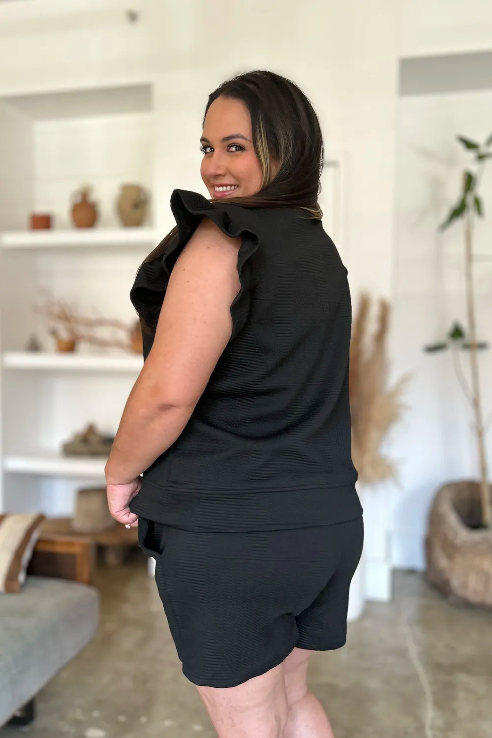 Black double take full-size texture flounce sleeve top and shorts set by Trendsi, featuring stylish sleeve details and comfortable fit.