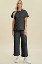 Black Trendsi Double Take texture round neck short sleeve top and matching pants set, casual and comfortable for everyday wear.