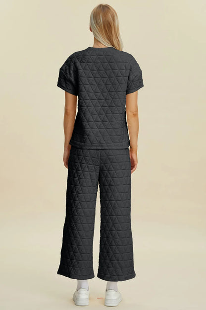 Black Trendsi Double Take full-size texture round neck short sleeve top and matching pants set, casual and stylish ensemble.