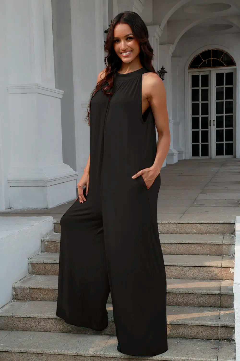 Black Trendsi Double Take sleeveless jumpsuit with tie-back and cutout details, full-size, stylish and modern for versatile wear.