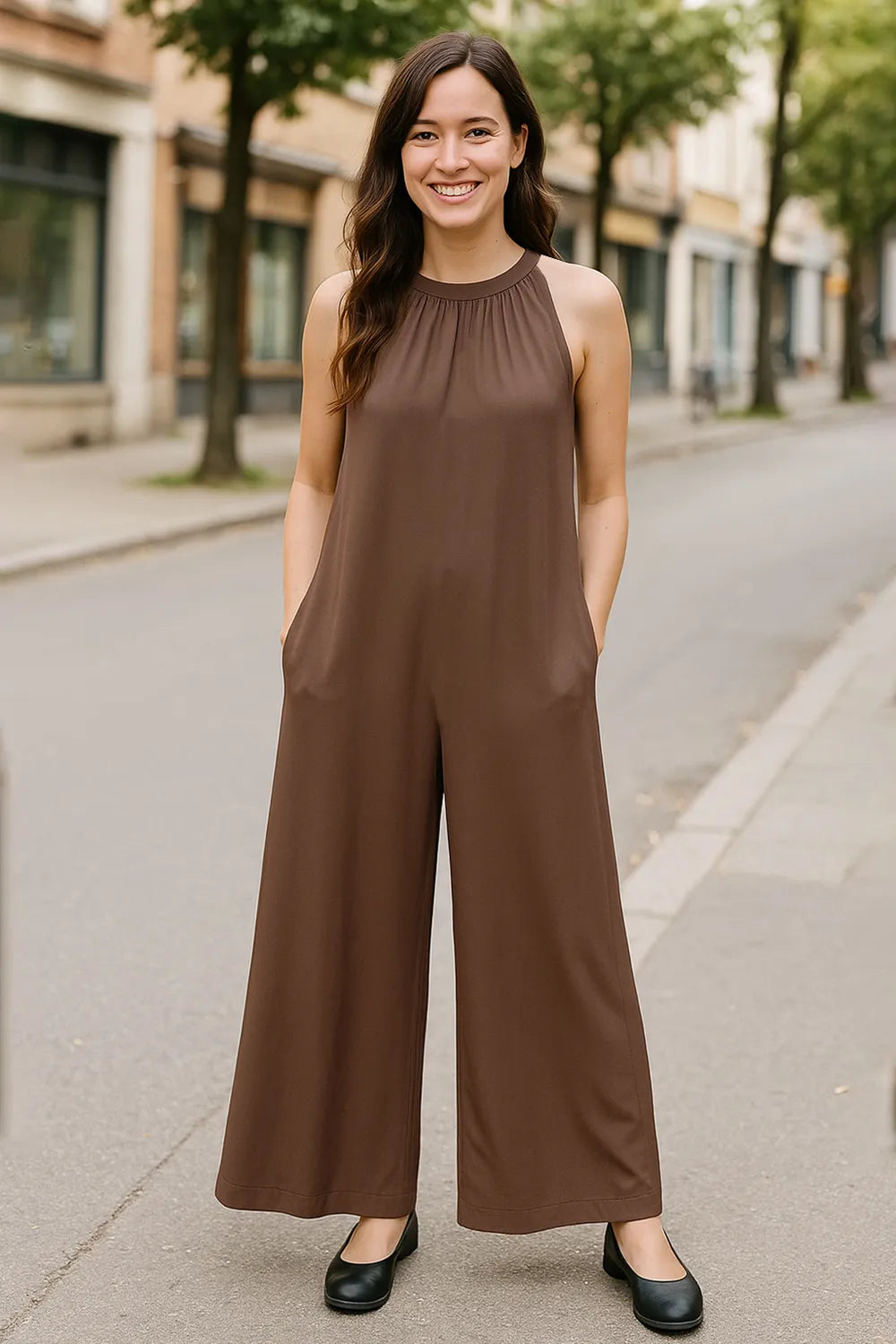 Black sleeveless jumpsuit with tie-back and cutout details, featuring a full-size fit from Trendsi.