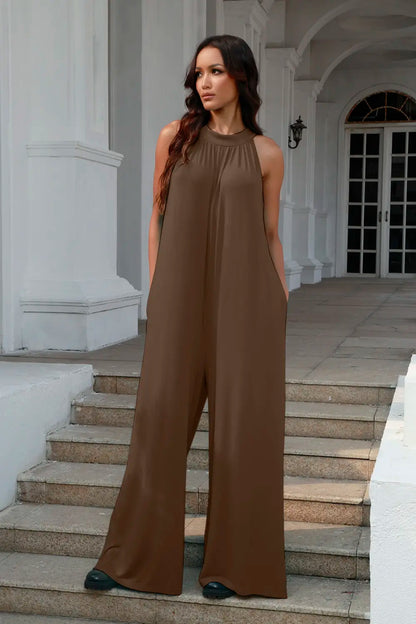 Black sleeveless jumpsuit with tie-back and cutout details, featuring a full-size fit and stylish design by Trendsi.
