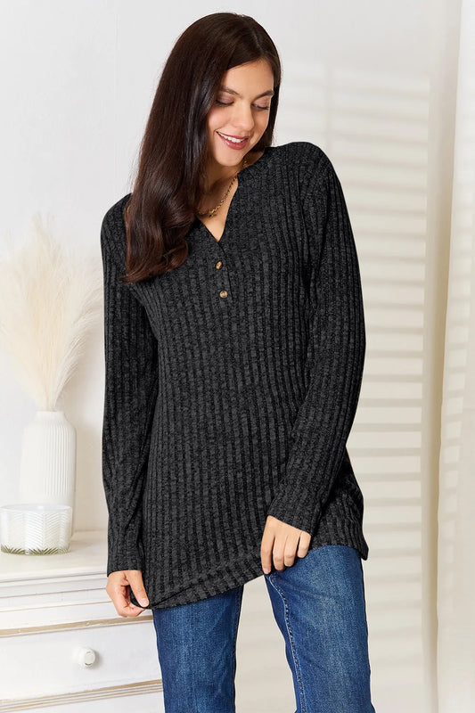 Black ribbed long sleeve T-shirt with a notched neckline by Trendsi, featuring a fitted design and long sleeves.