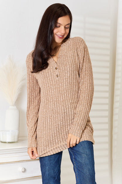 Black ribbed long sleeve T-shirt with a notched neckline from Trendsi, featuring a fitted design and long sleeves.