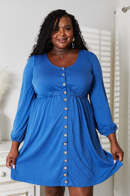Black Trendsi Double Take scoop neck empire waist long sleeve magic dress shown on a model. Elegant and figure-flattering design.