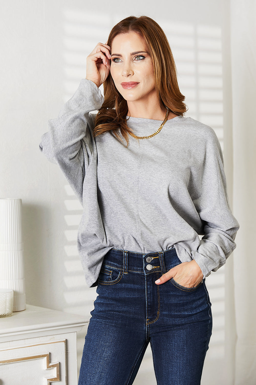 Black long sleeve top with seam details and round neckline from Trendsi's Double Take collection.