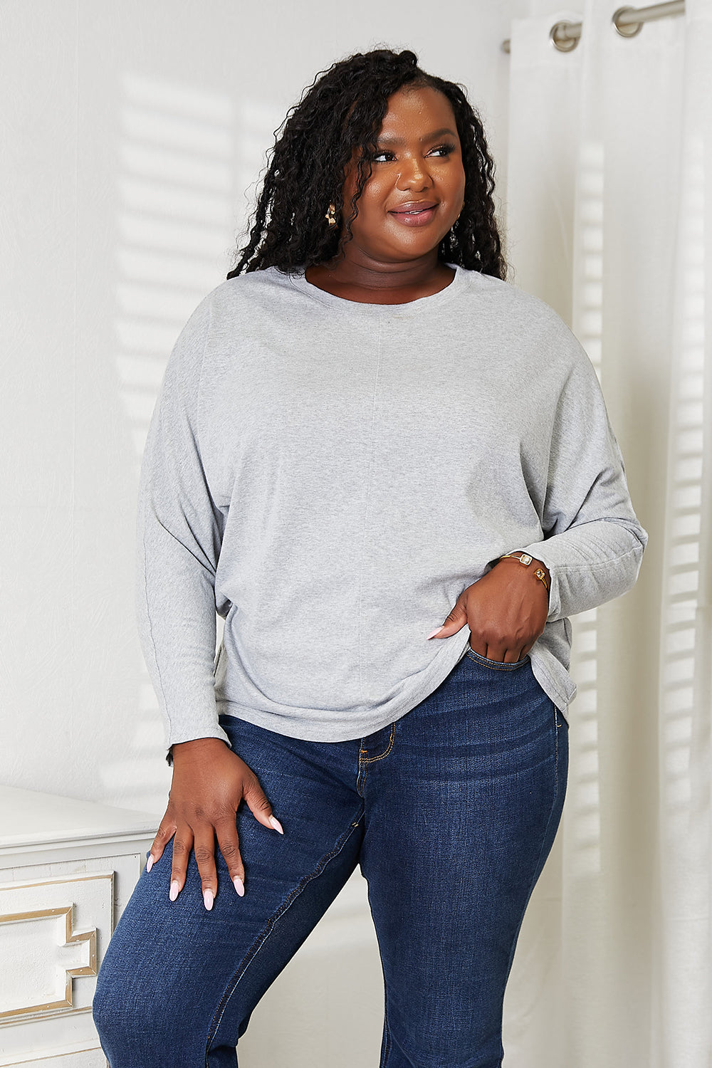 Black long sleeve top with seam details and round neckline from Trendsi's Double Take collection.