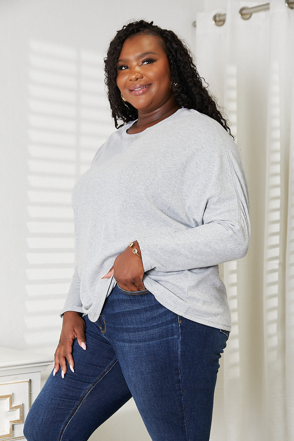 Black long sleeve top with seam detail, round neck, by Trendsi, featuring a stylish, fitted design.