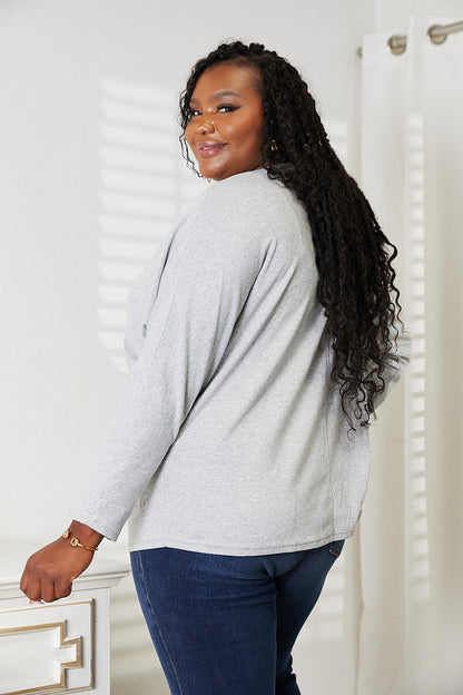 Black long sleeve top with seam details and round neckline from Trendsi, shown on a model.
