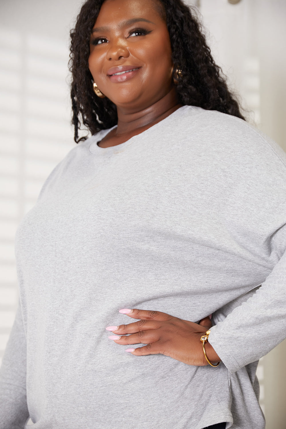 Black Trendsi Double Take seam detail round neck long sleeve top, close-up showing fabric texture and seam accents.