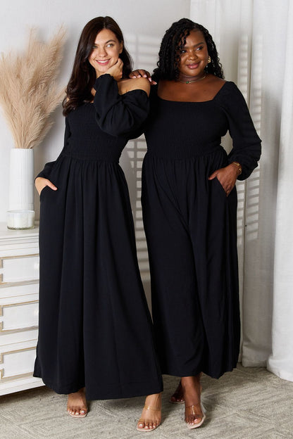 Black Trendsi Double Take square neck jumpsuit with pockets, featuring a fitted bodice and wide-leg pants for a stylish look.