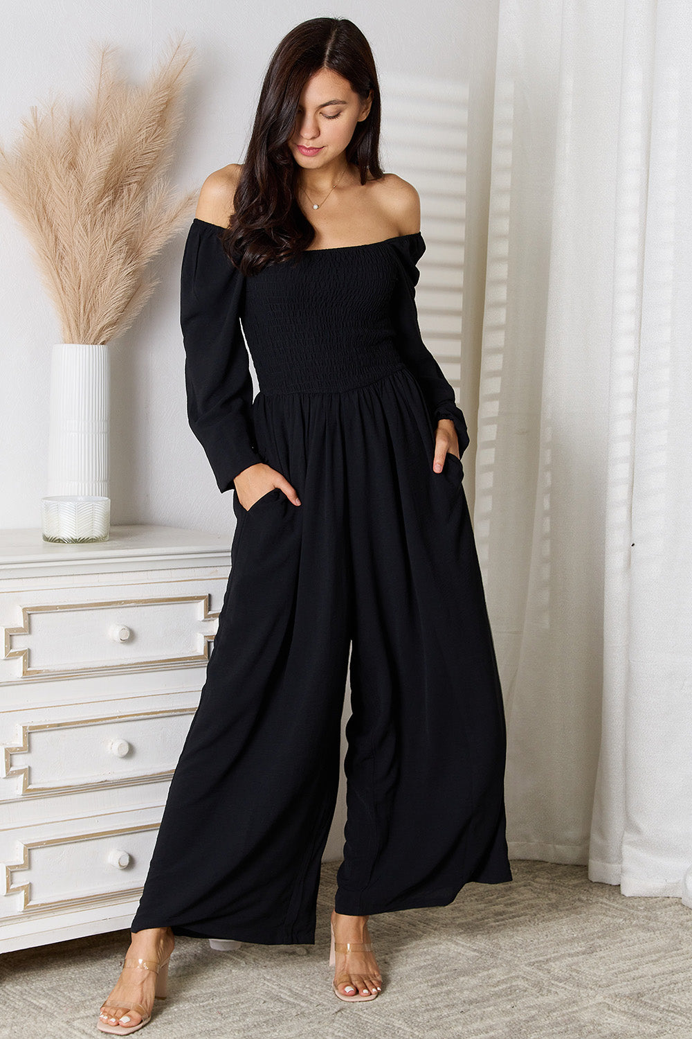 Black double take square neck jumpsuit with pockets from Trendsi, featuring a fitted bodice and wide-leg pants.