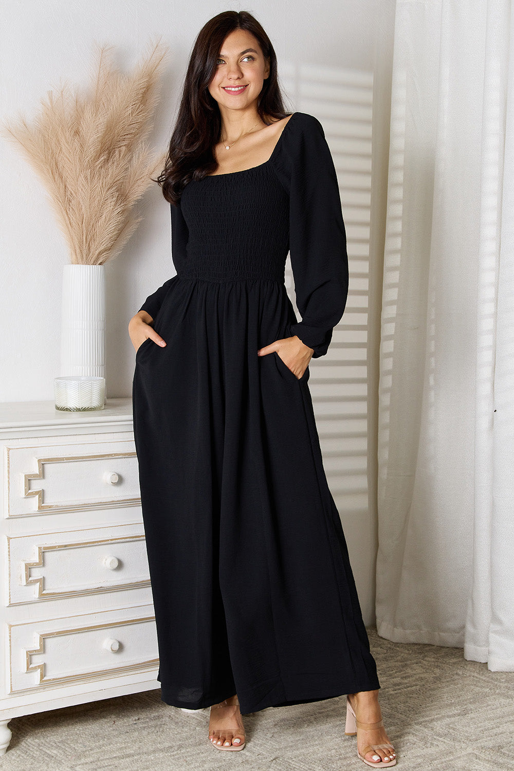 Black double take square neck jumpsuit with pockets from Trendsi, styled with a fitted silhouette and sleeveless design.