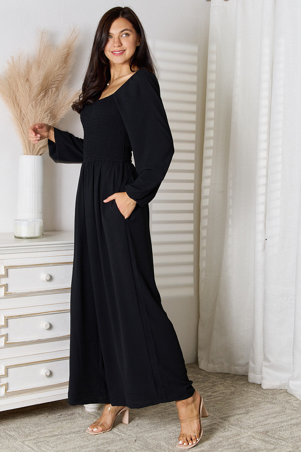 Black Trendsi Double Take square neck jumpsuit with pockets, featuring a fitted bodice and wide-leg pants.