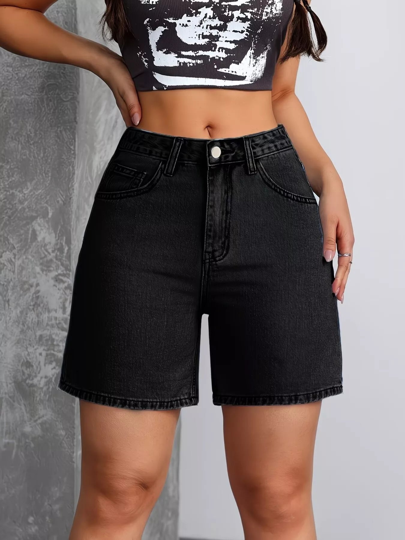 Black high-waisted denim shorts by Trendsi, featuring a fitted waist and casual style, shown on a model.
