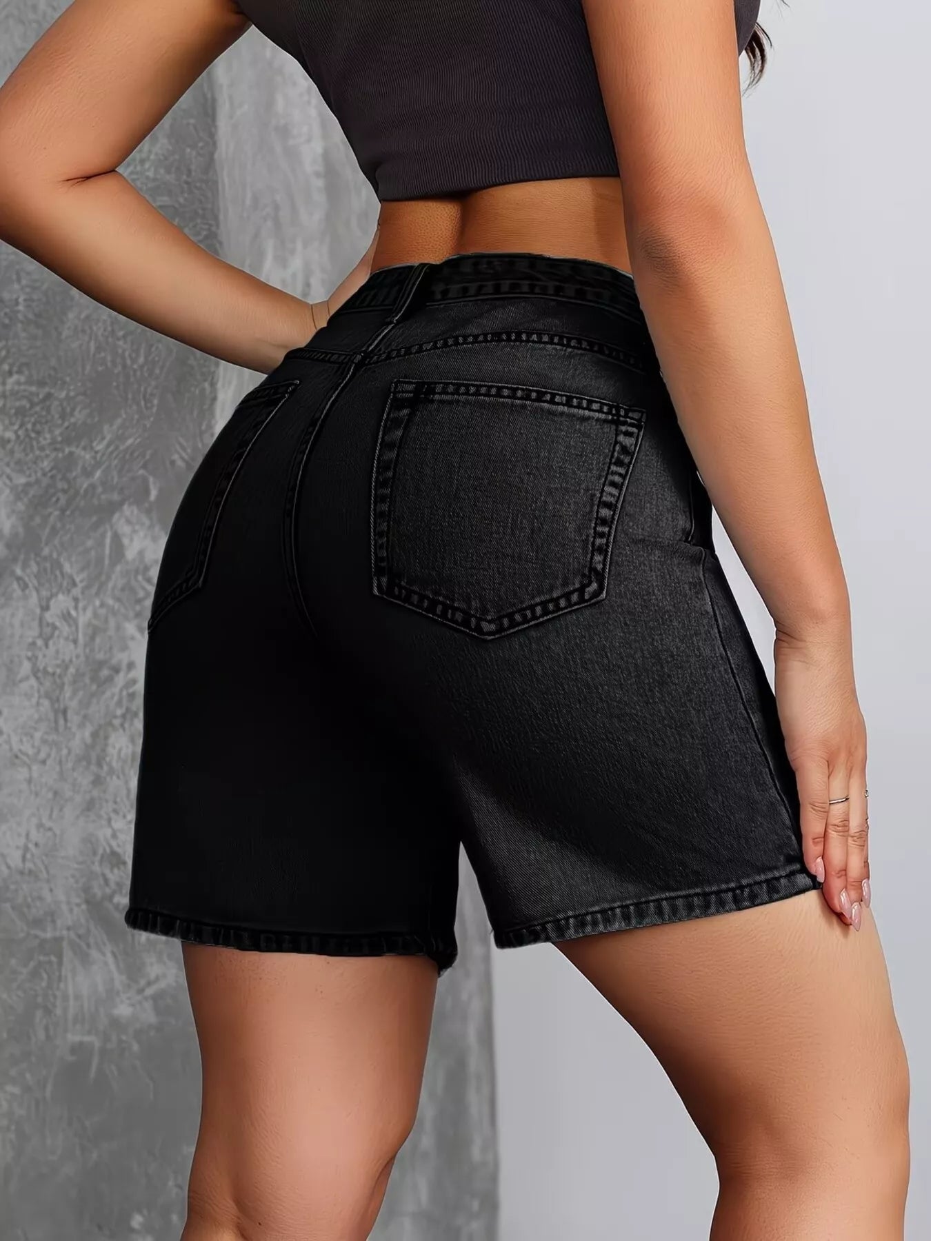 Black high-waisted denim shorts by Trendsi with a relaxed fit and classic five-pocket design, perfect for casual summer wear.