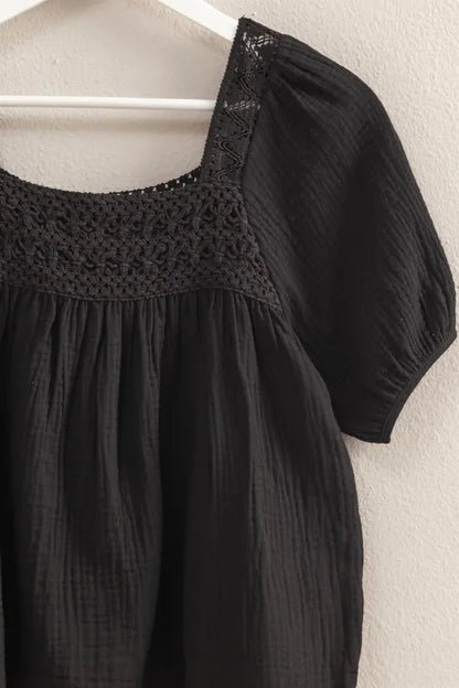Black HYFVE crochet detail puff sleeve peasant top with billowy sleeves and relaxed fit, styled on a model.