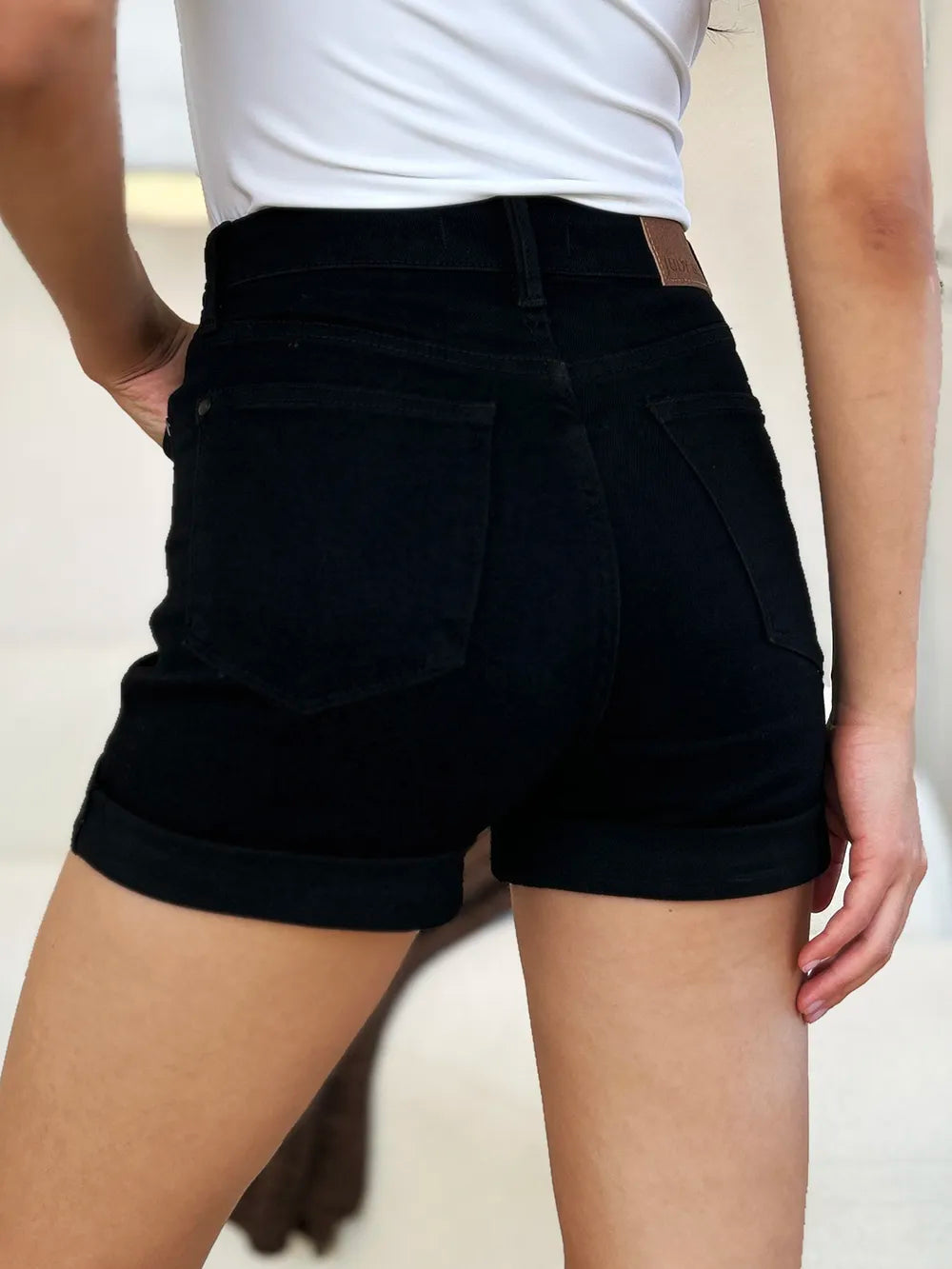 Black Judy Blue high waist denim shorts with tummy control and cuffed hem, designed for full size fit and casual style.