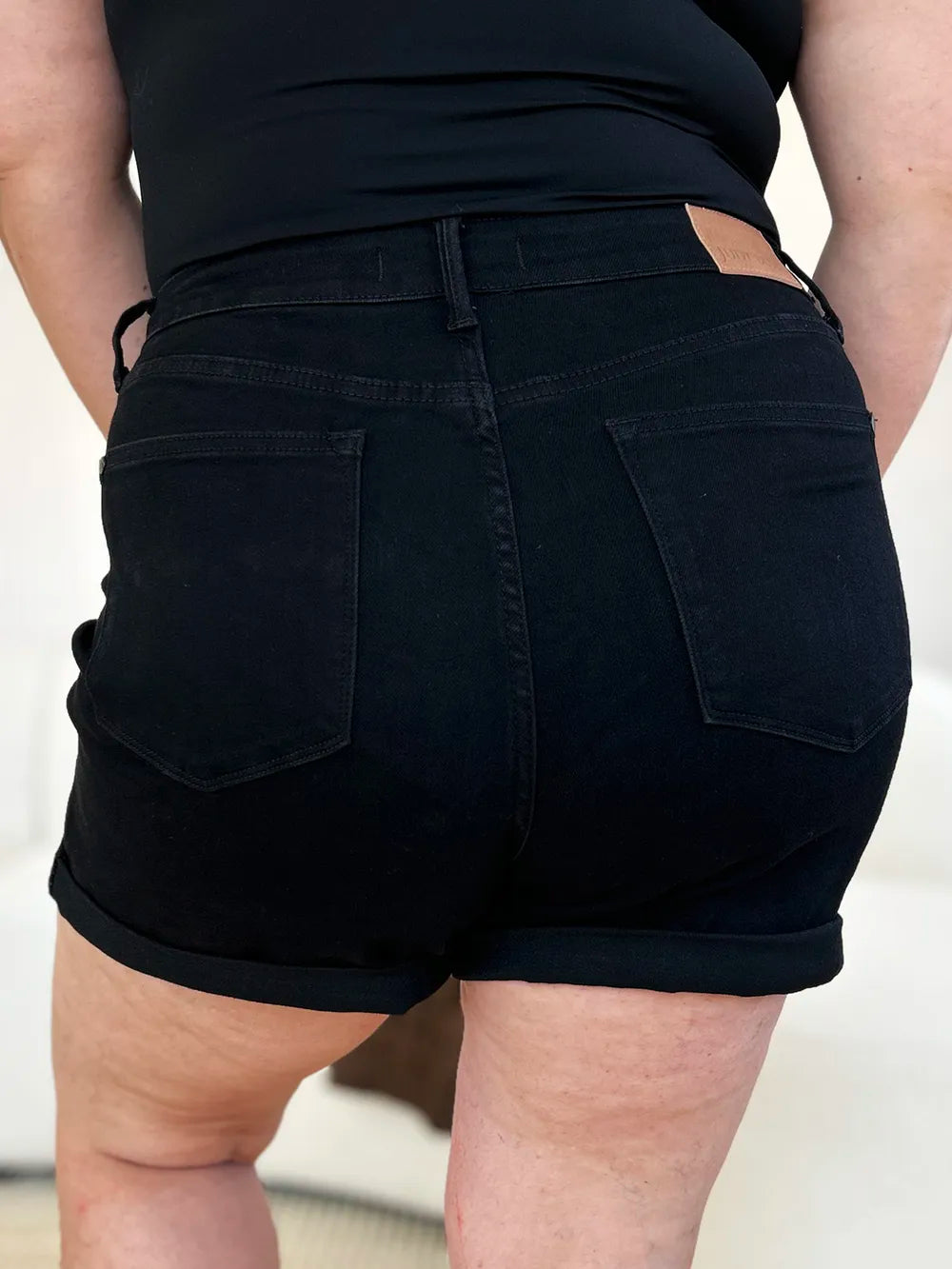 Black Judy Blue high-waist denim shorts with tummy control and cuffed hem, designed for full-size fit.