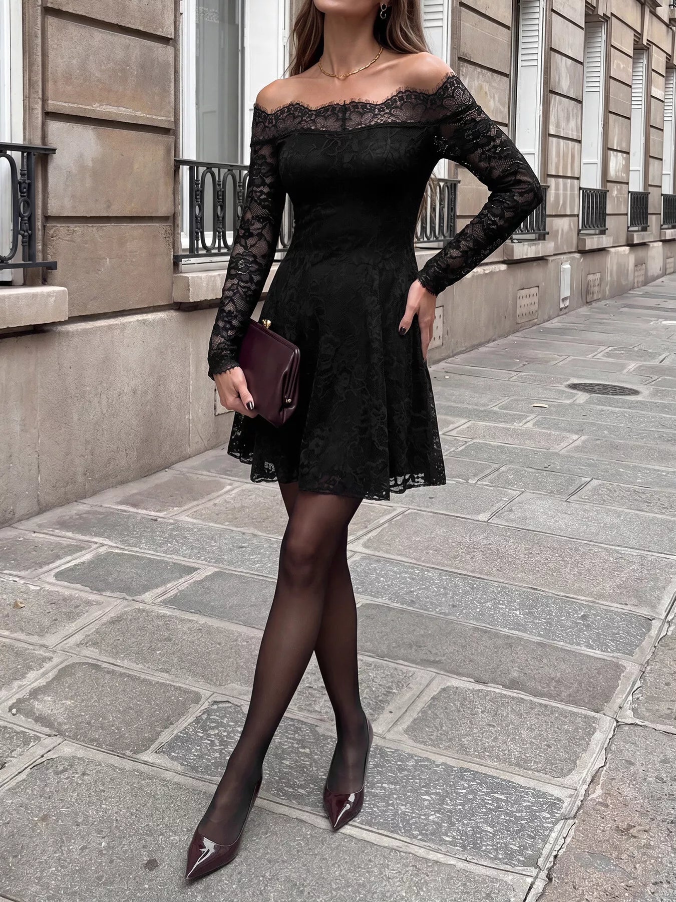 Black lace off-shoulder mini dress by Trendsi, featuring a fitted design with long sleeves and a stylish neckline.