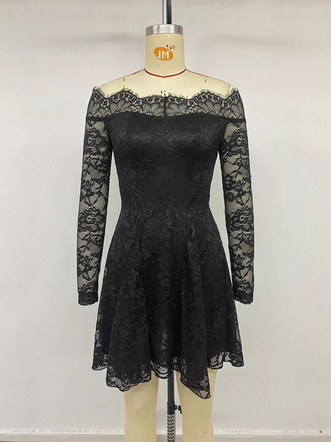 Black lace off-shoulder mini dress by Trendsi with long sleeves, fitted silhouette, and elegant design, perfect for stylish occasions.