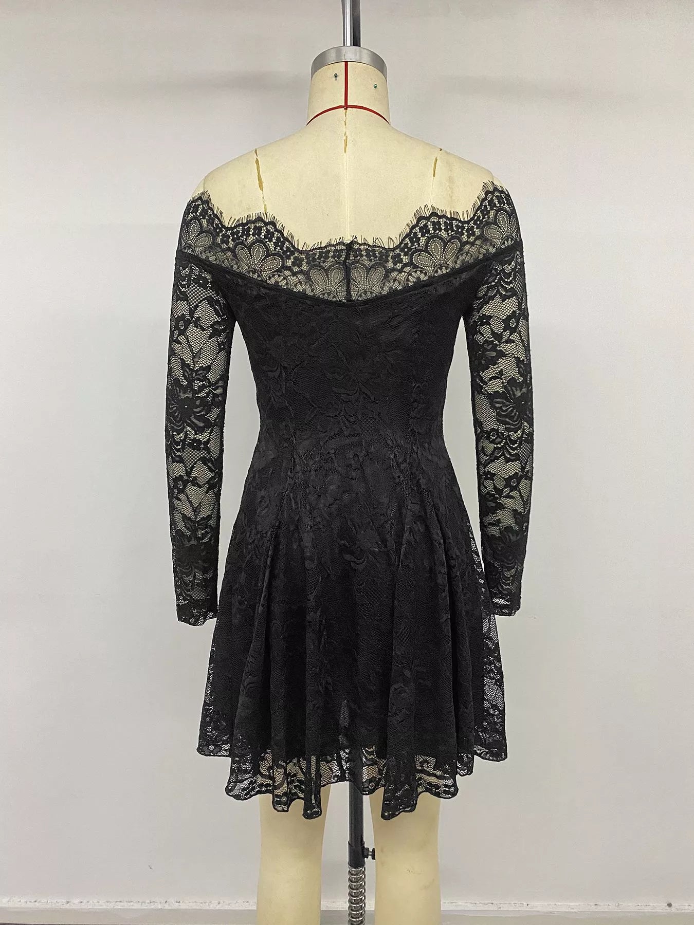 Black lace off-shoulder mini dress from Trendsi, featuring a fitted silhouette and delicate lace details.