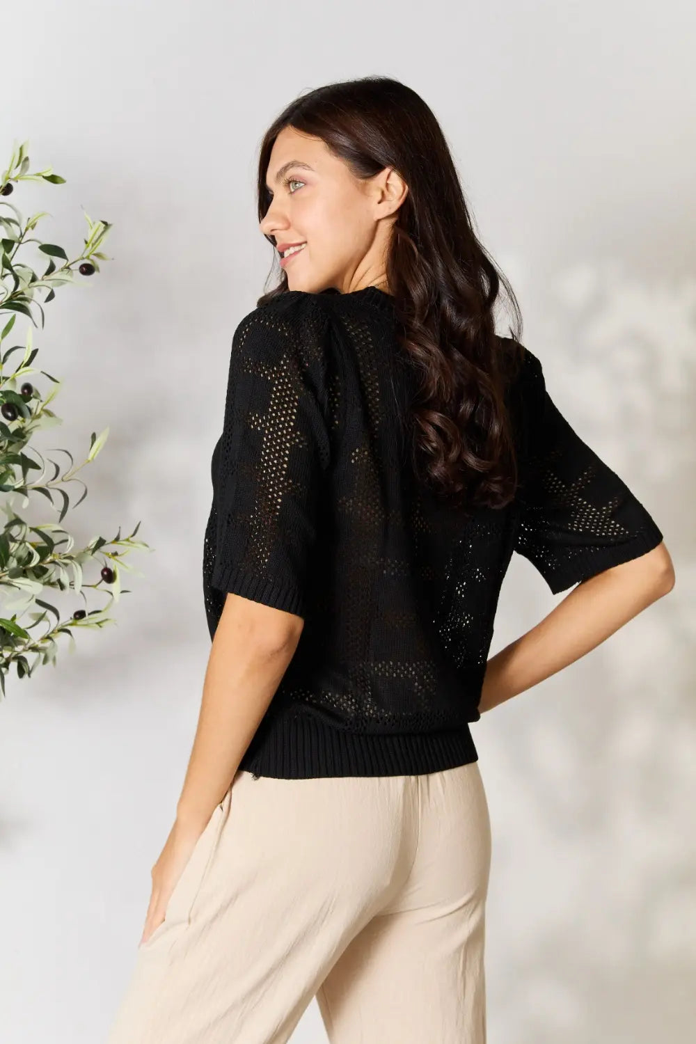 Black Mandy Ribbed Trim Round Neck Knit Top by Trendsi, showcasing a close-up of the ribbed fabric and round neckline.