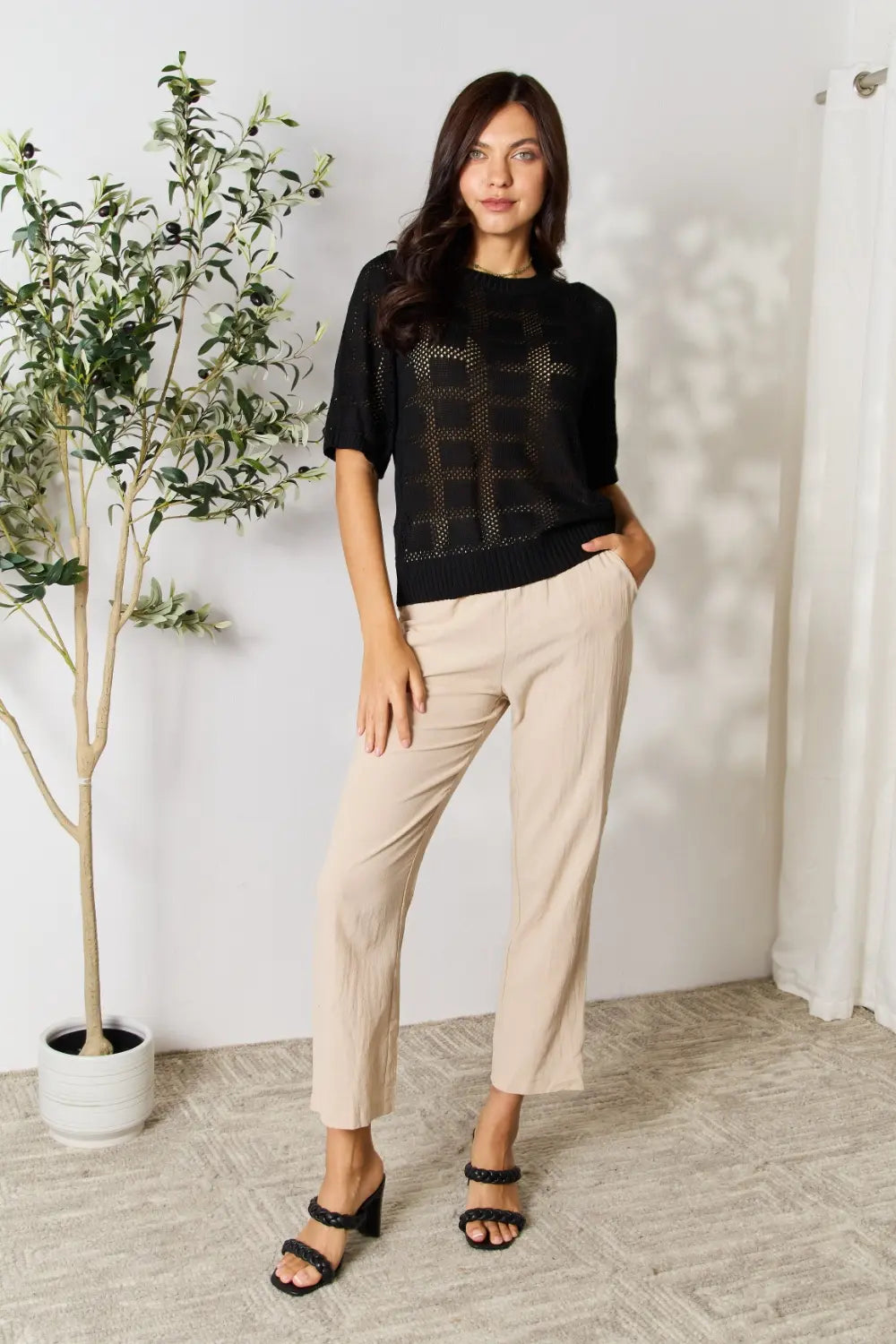 Black Mandy ribbed trim round neck knit top by Trendsi, featuring a close-up of the textured fabric and stylish neckline.