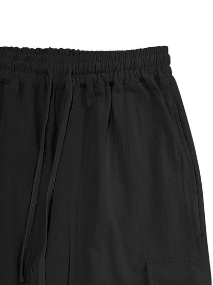 Men's black full-size casual cargo pants with drawstring waist, plus size, from Trendsi, shown with relaxed fit and functional pockets.