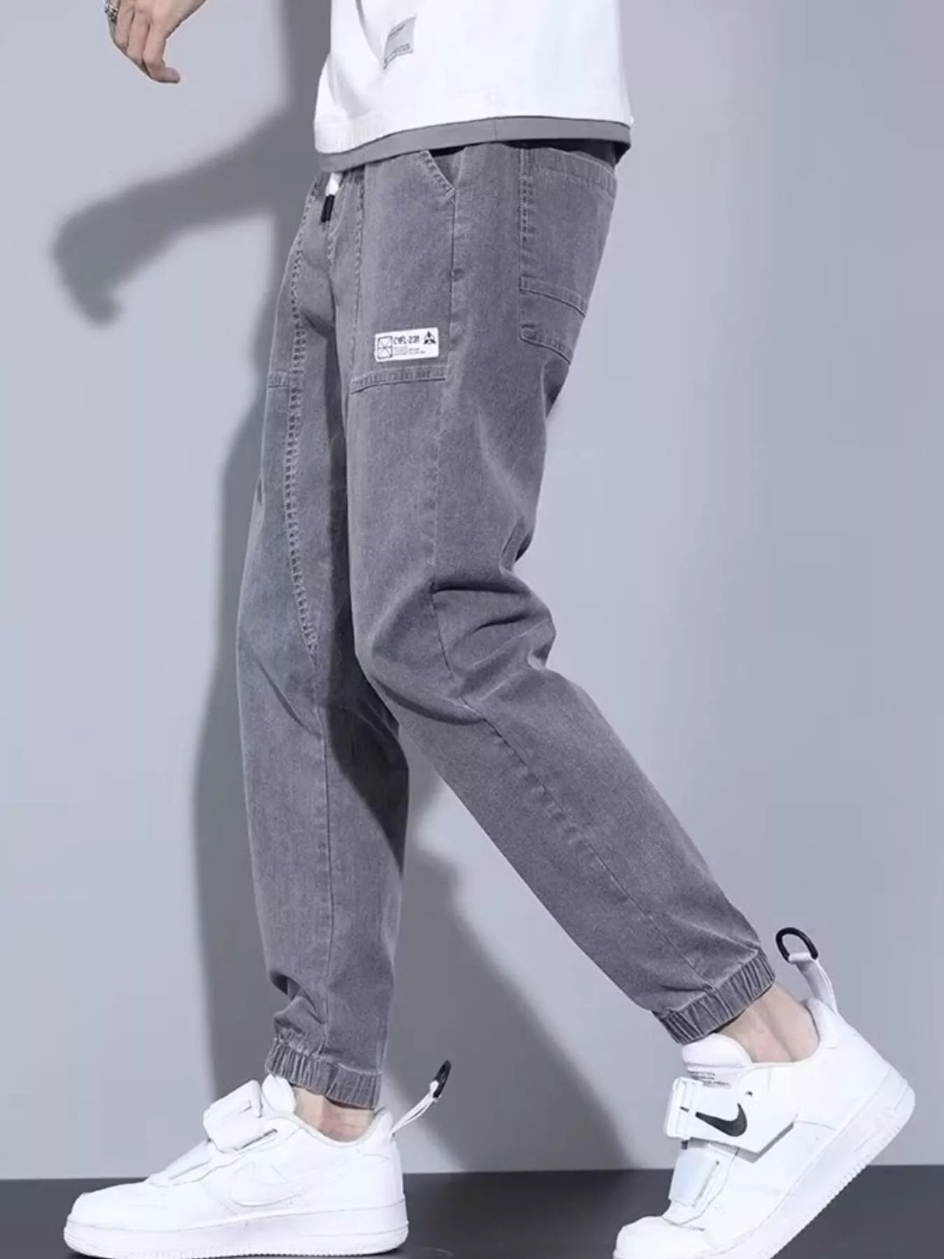 Men's full size black denim joggers by Trendsi, casual loose fit plus size jeans with comfortable relaxed style.