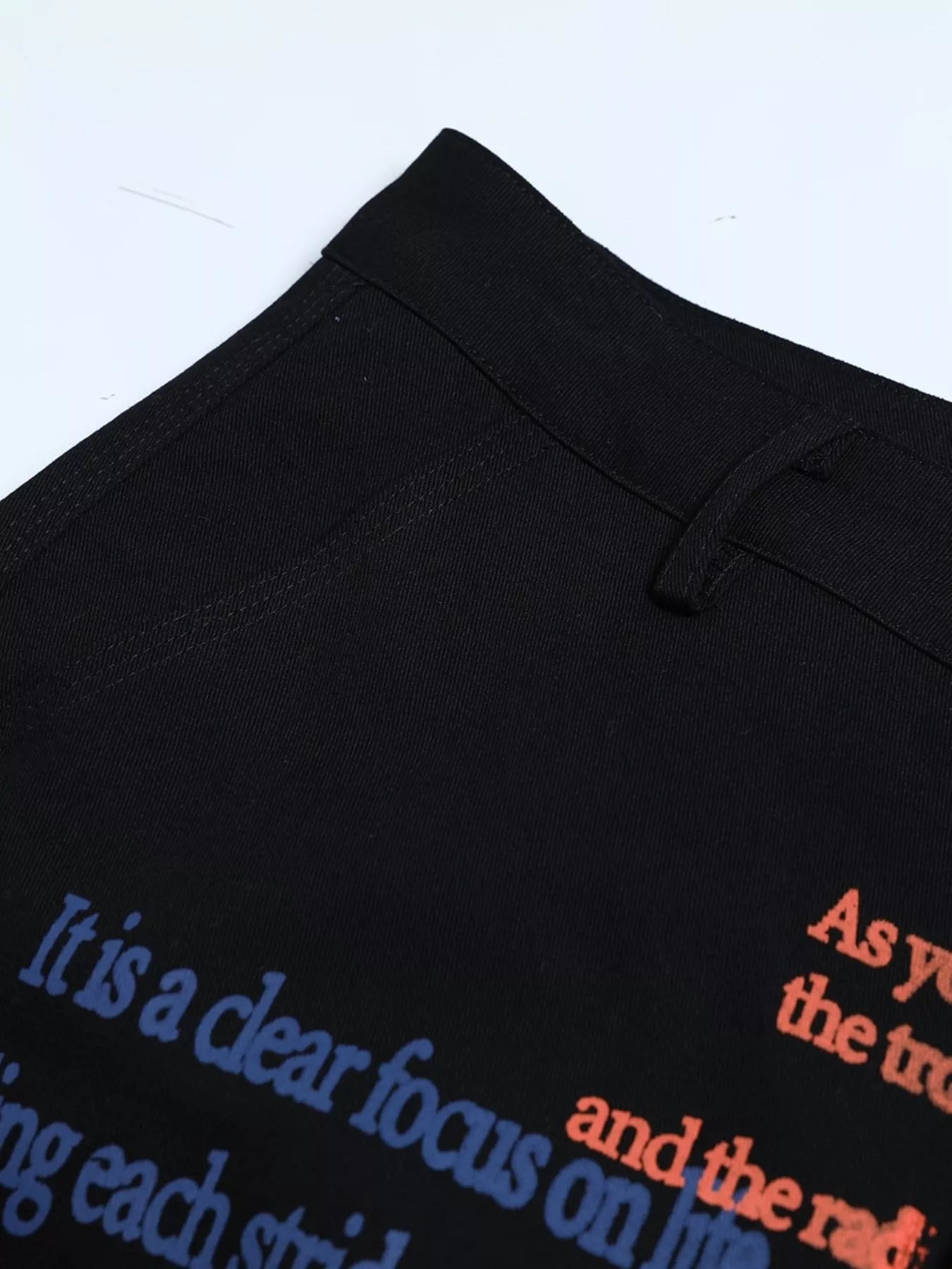 Black men's printed cargo pants from Trendsi featuring multiple pockets and a casual, comfortable fit.