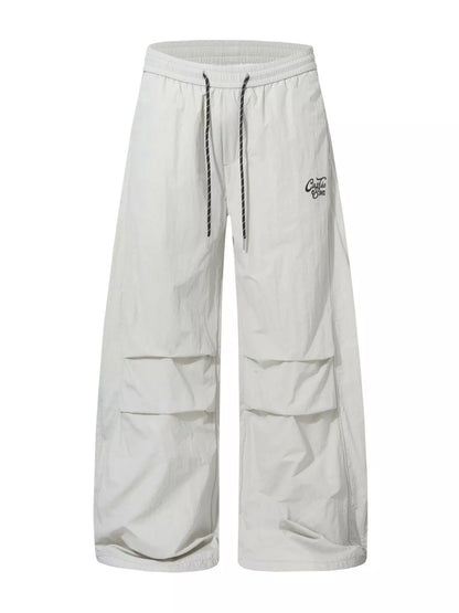 Black men's wide-leg cargo pants from Trendsi, featuring multiple side pockets and relaxed fit for casual style.