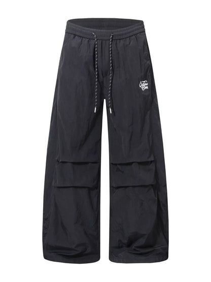 Men's black wide-leg cargo pants by Trendsi, featuring multiple pockets and relaxed fit, displayed on a neutral background.