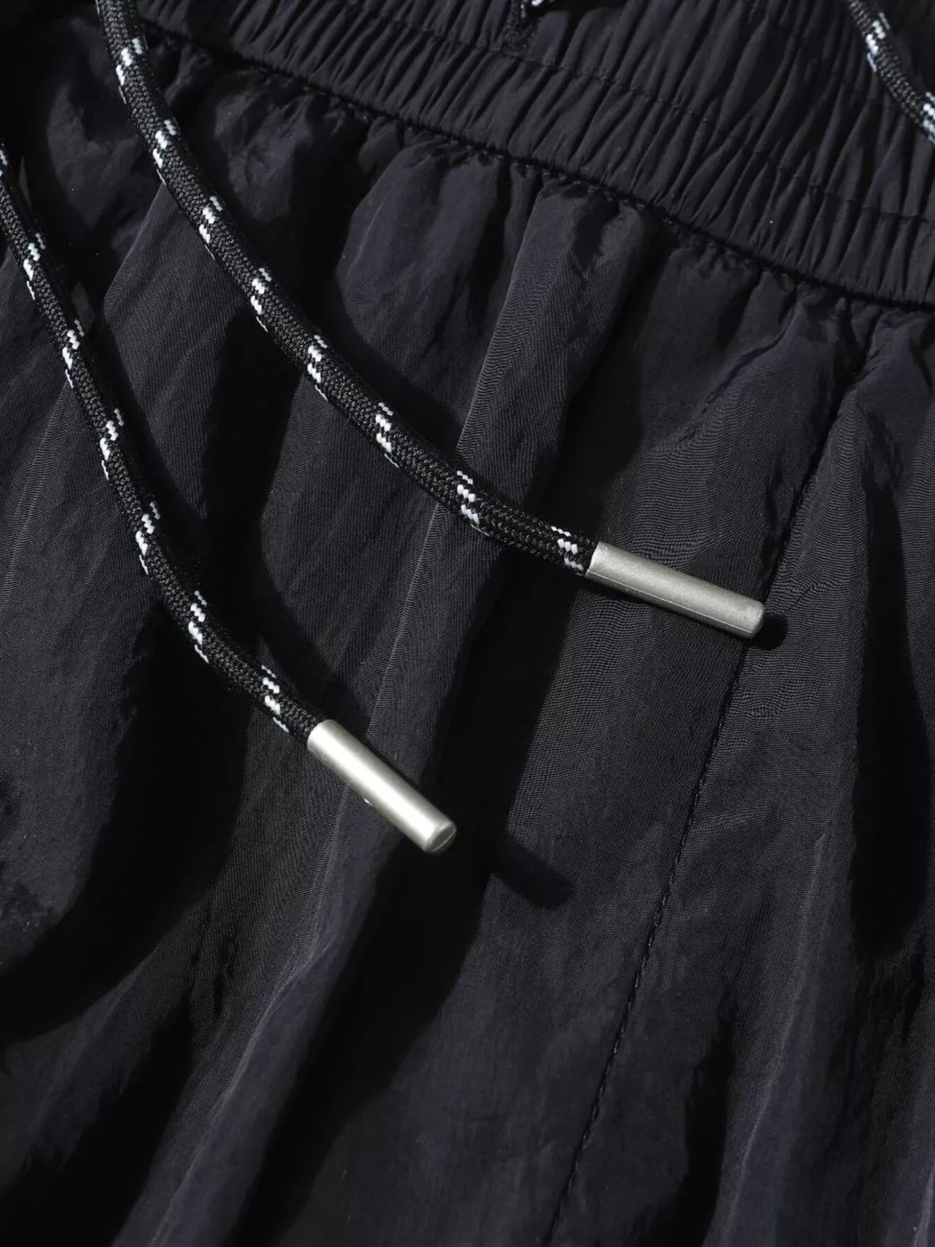 Men's black wide-leg cargo pants by Trendsi, featuring multiple pockets and relaxed fit, displayed on a plain background.